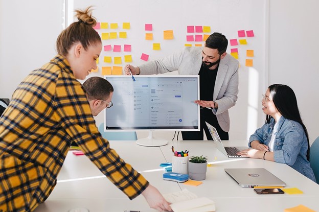man standing behind flat screen computer monitor man standing behind flat screen computer monitor