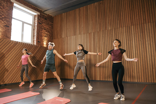 People in the Fitness Center Doing Jumping Jacks People in the Fitness Center Doing Jumping Jacks